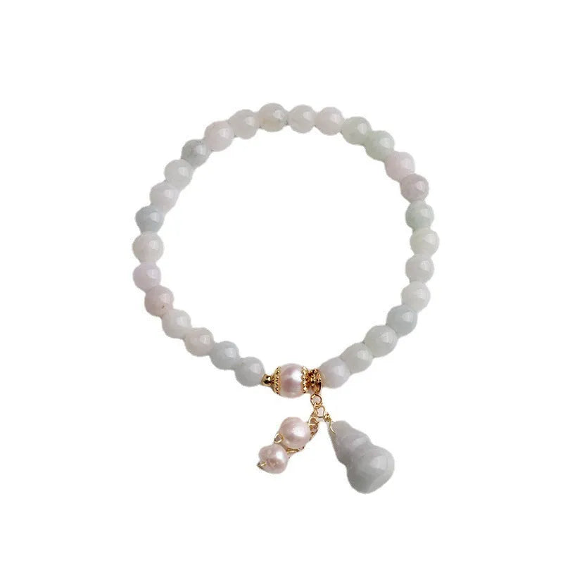 Chinese style jade bracelet with gourd design on woman's wrist