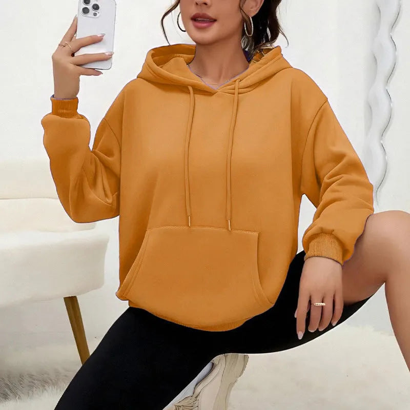 A loose-fitting women's long-sleeve sweatshirt with a drawstring pocket, shown in a solid colour.