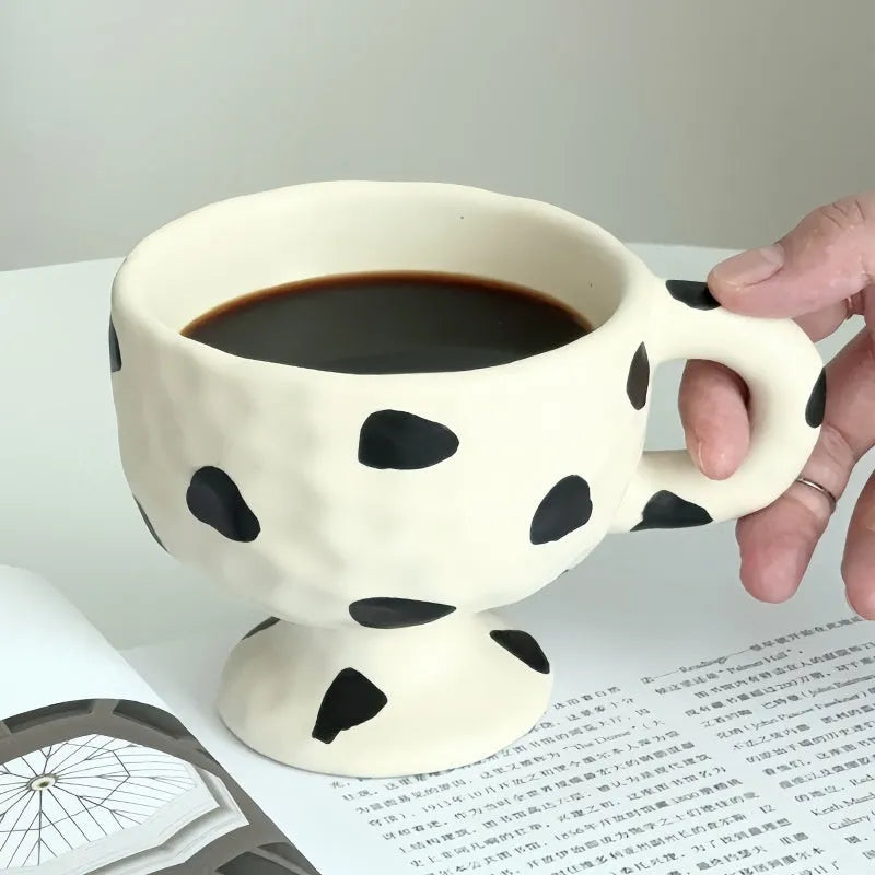 Hand-pinched irregular ceramic mug in solid colour with modern simple style, shown from side angle