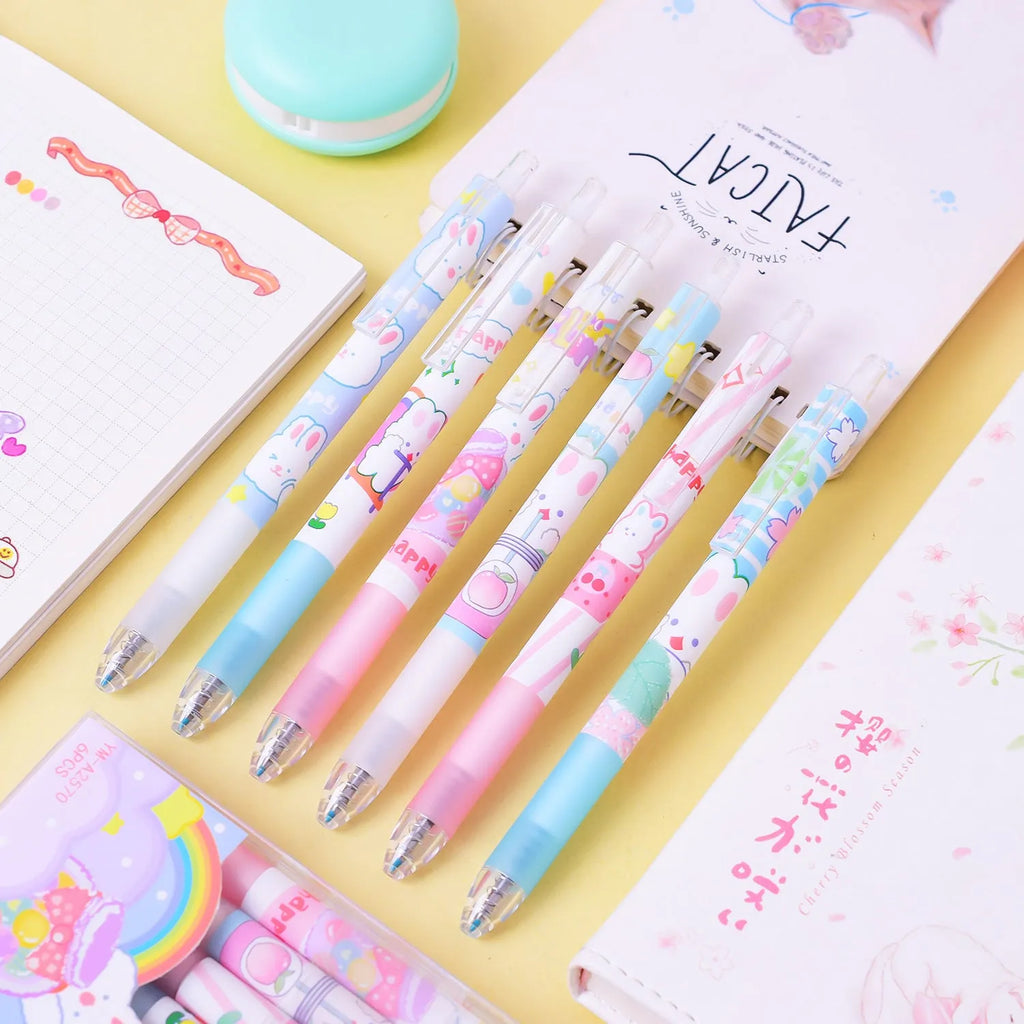Set of six white plastic pens with black caps and a cartoon bunny character printed on the barrel.