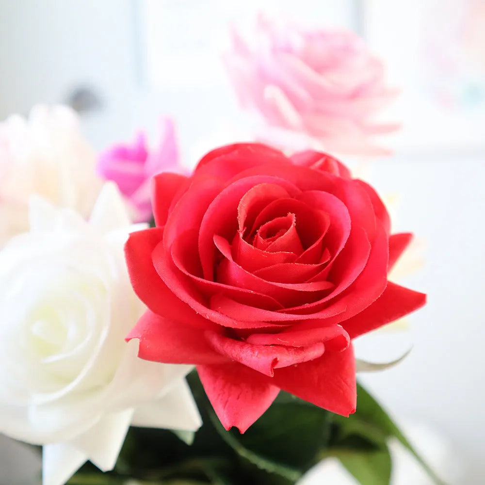 Artificial silk rose bouquet with red fabric flower head and green plastic stem