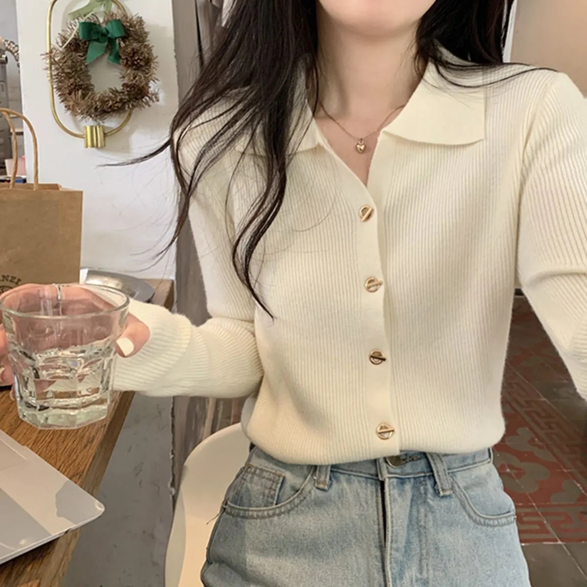 Beige loose fit long-sleeved viscose knitted cardigan top worn open as a layer.