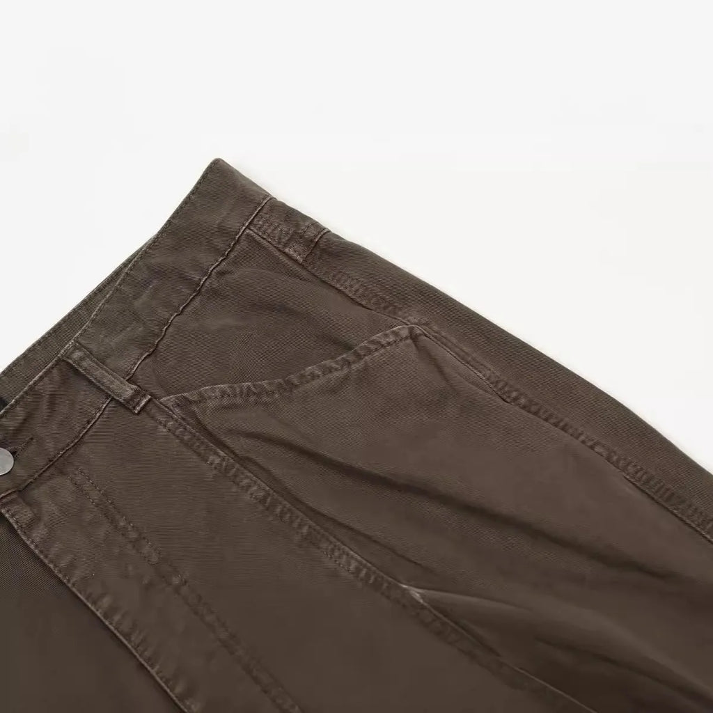 Men's brown loose straight-leg trousers with high waist and wide leg opening on a hanger