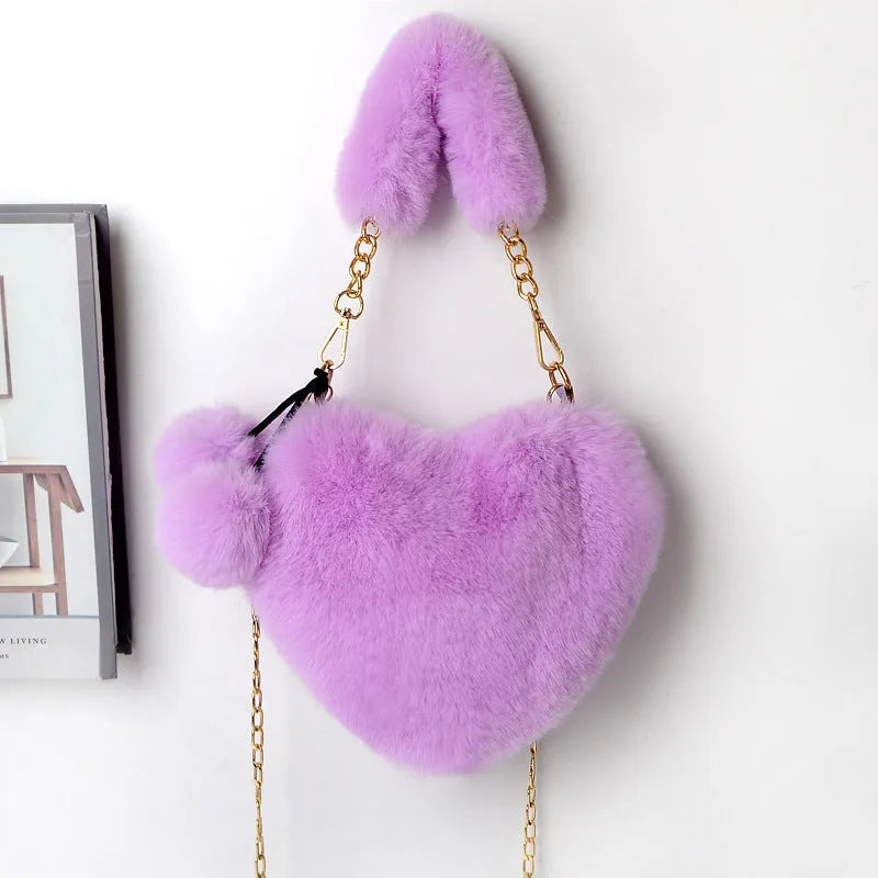 A soft plush heart-shaped women's handbag with a zipper and a detachable shoulder strap in a choice of 14 colours.