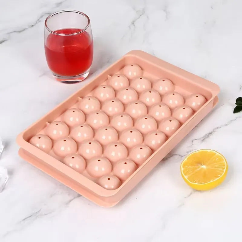 Blue silicone ice cube tray with lid showing 33 round compartments for homemade ice