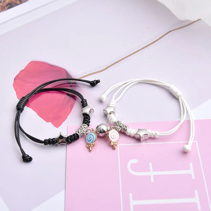Alloy couple bracelets with magnet closure showing various design options including crown, clover, and text patterns