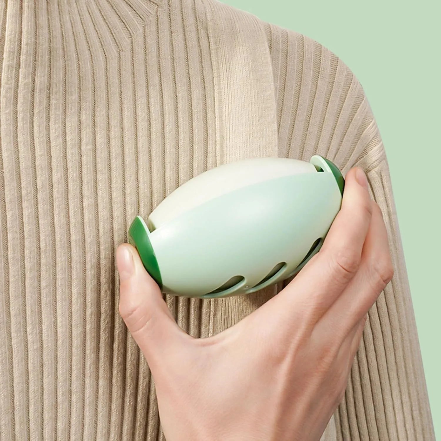 Green and white reusable gel lint roller ball for pet hair removal from clothes and furniture