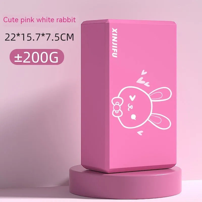 High-density EVA yoga block in violet colour next to a pink block with a cartoon print design.