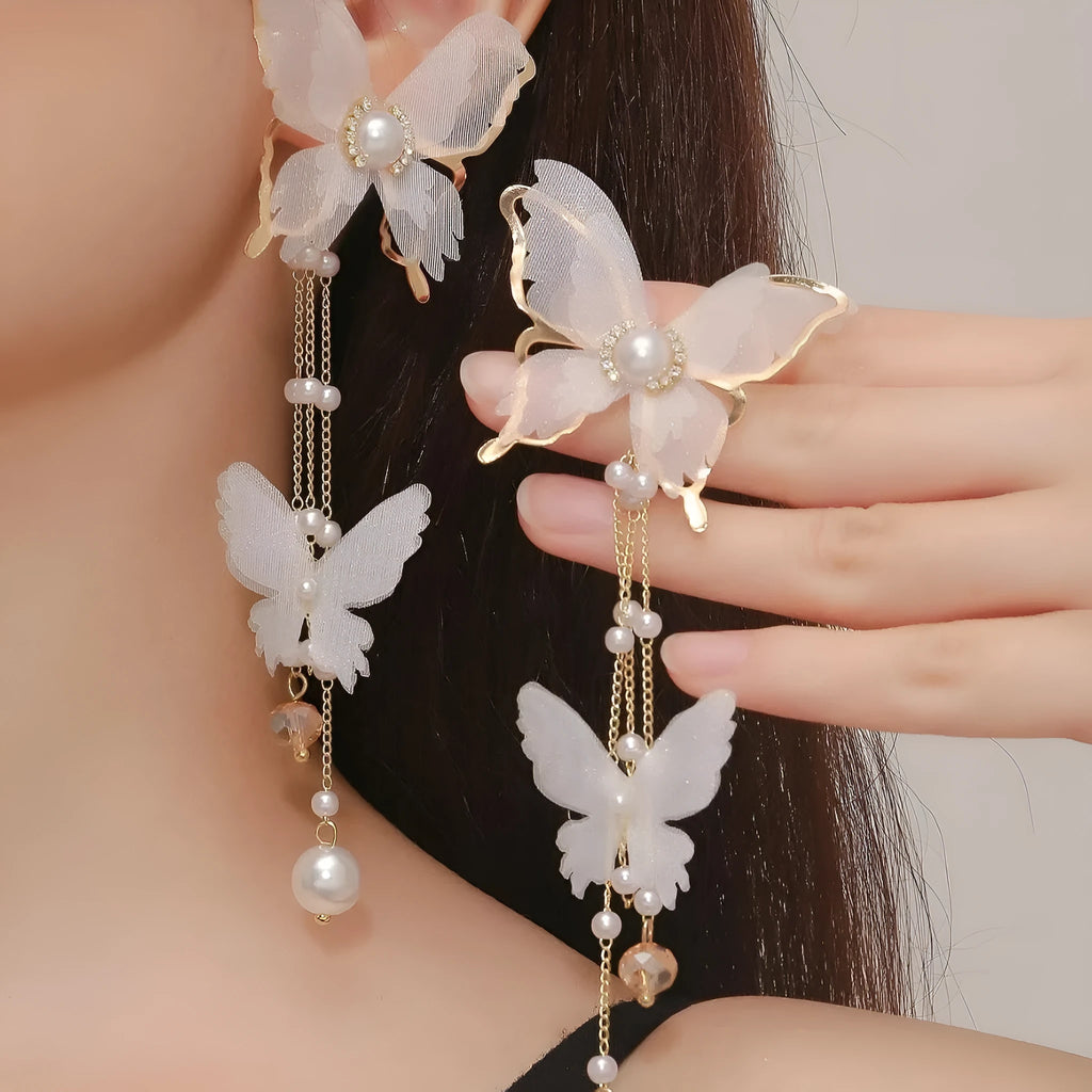 White butterfly earrings with lace patterns, rhinestones, pearls and tassel drops