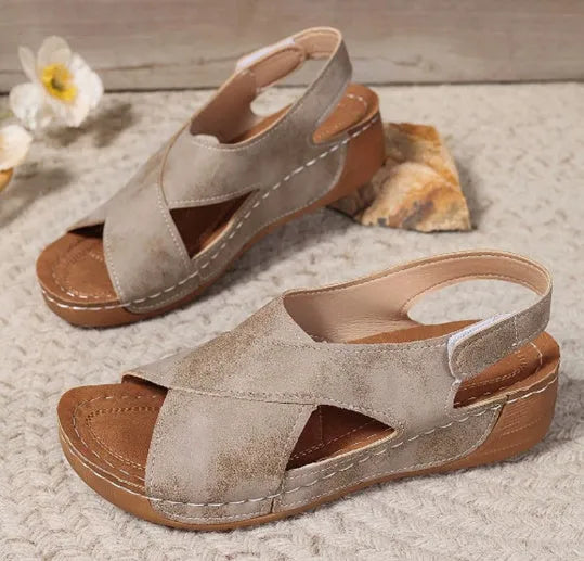 Women's brown platform Roman sandals with Velcro strap and open toe on a rubber sole.