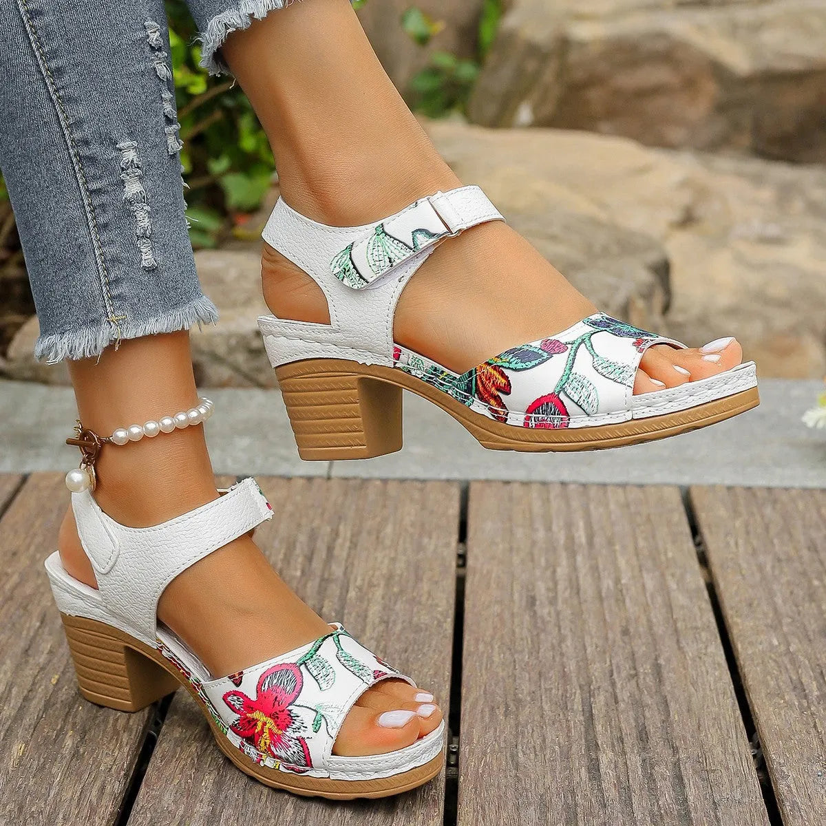 White women's high heel sandals showing the velcro buckle fastening on the strap.