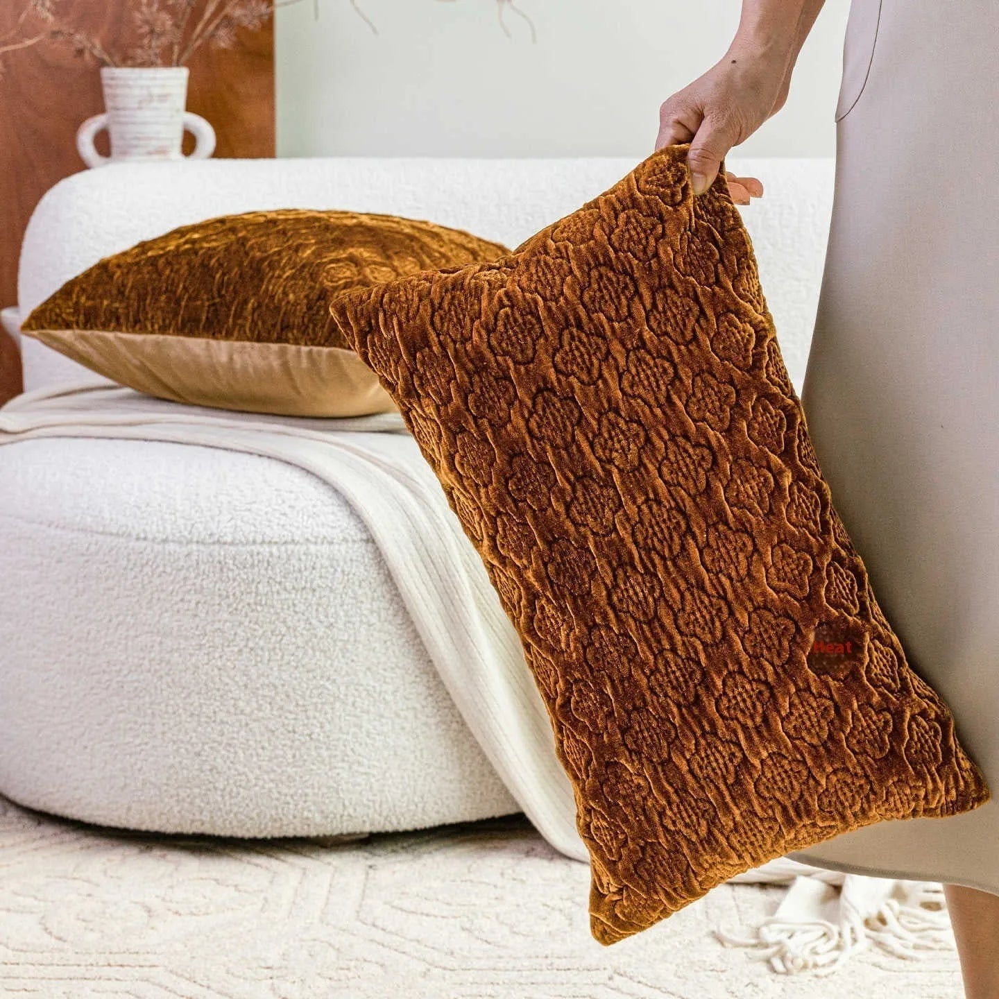 Brown gold antique-style three-dimensional quilted cushion pillow on a sofa