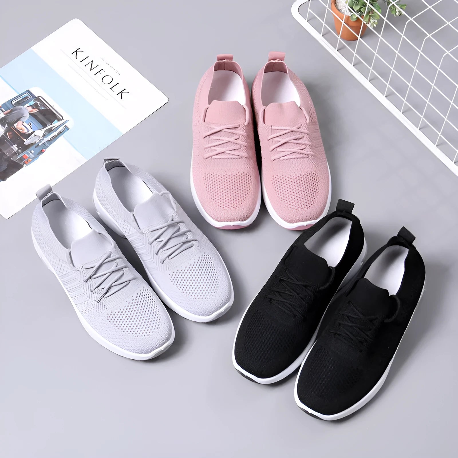 Women's black mesh casual sneakers with round toe and white non-slip sole on a grey background.