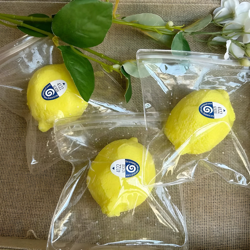 Yellow silicone lemon squeezing toy on a flat surface used for stress relief and sensory play