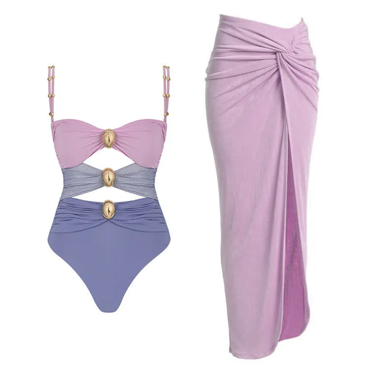 Women's solid colour one-piece swimsuit with gold button and separate matching skirt.