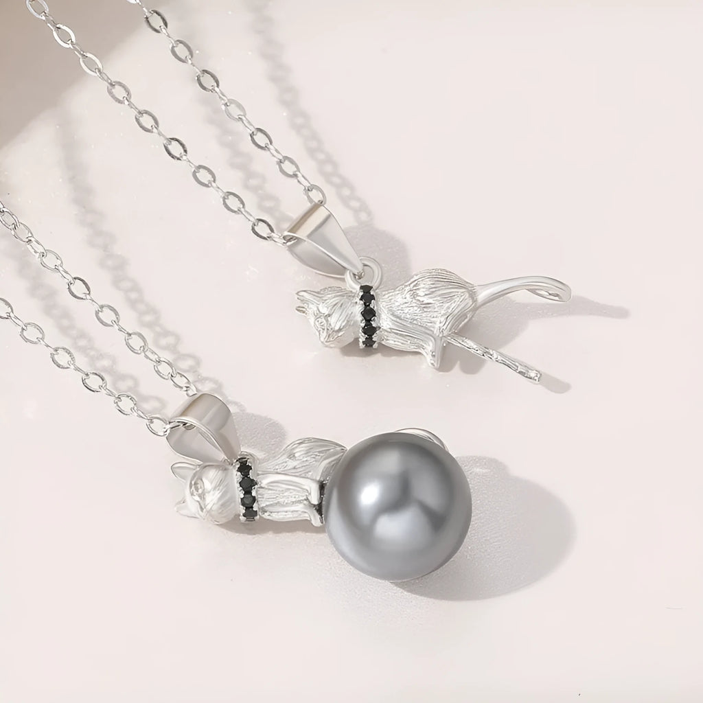 Close-up of a sterling silver cat silhouette pendant on a clavicle-length chain.