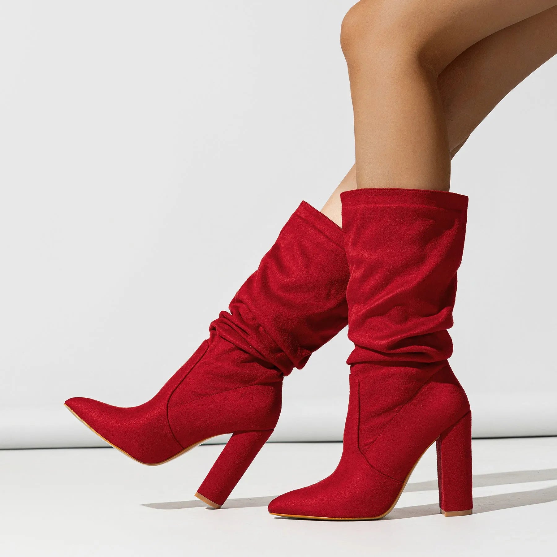 Women's black suede chunky heel pointed toe boots with super high heels and mid-calf length