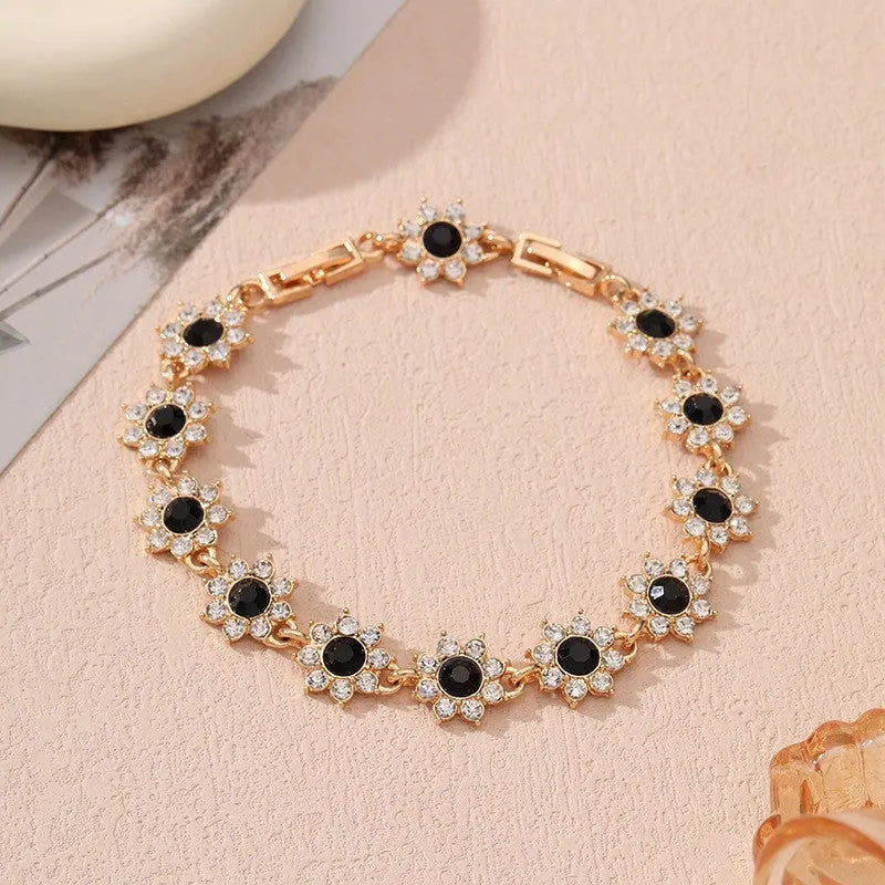 Electroplated zinc alloy flower bracelet in a choice of gold or silver finishes with coloured gemstone designs.