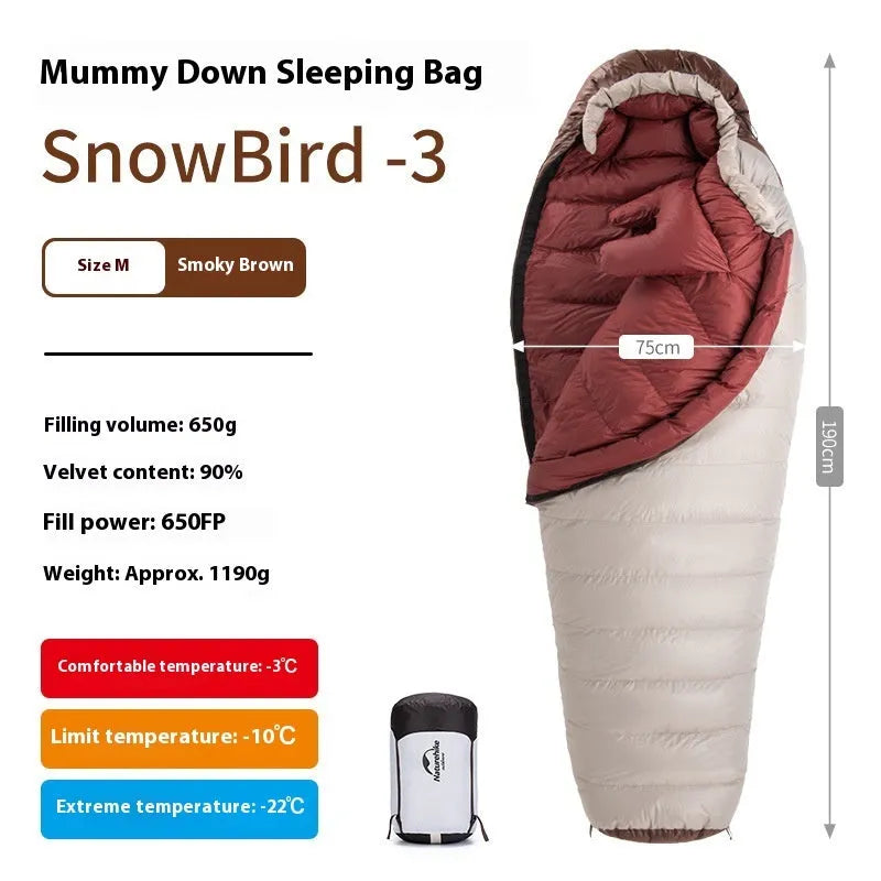 Adult mummy-style sleeping bag with goose down insulation shown with its storage bag.