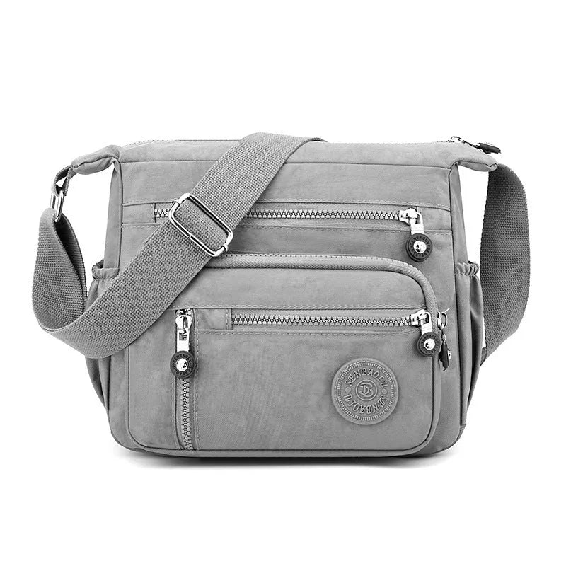Nylon messenger bag in square vertical shape with single shoulder strap, shown in one of five colour options