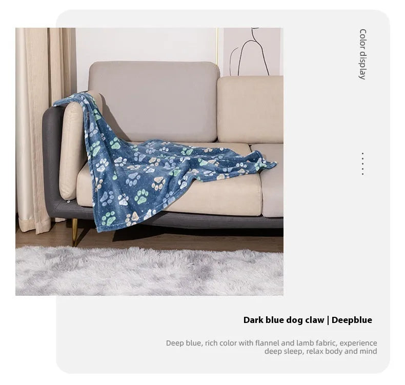 Blue cartoon dog paw patterned flannel pet blanket laid flat, showing its size.