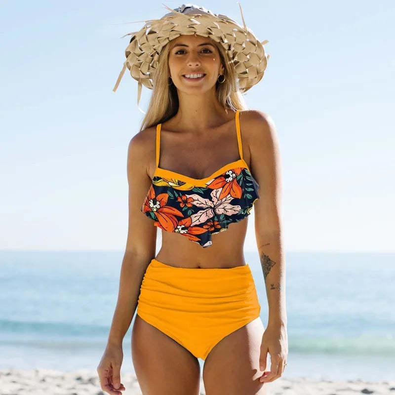 Women's blue high-waist bikini swimsuit with floral print and pleated pants.