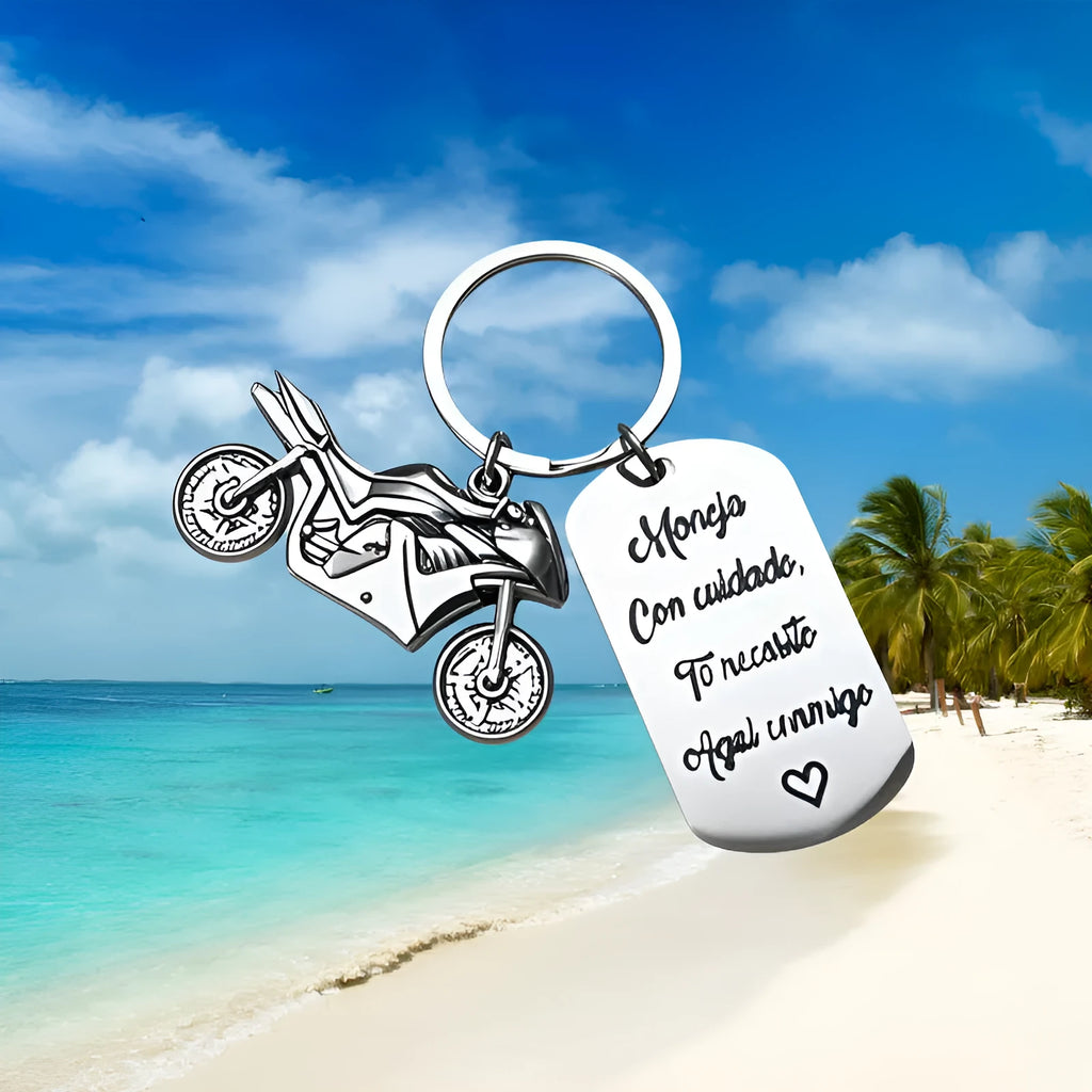 Stainless steel motorcycle keychain with inspirational design on a flannel bag.