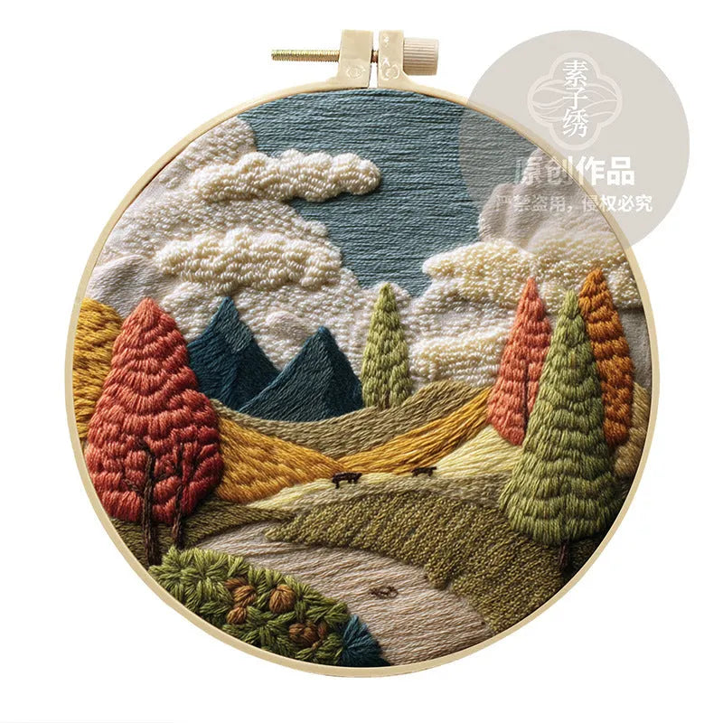 Embroidery kit with cotton fabric, bamboo frame, threads, and printed landscape design for DIY textile art