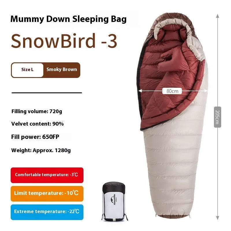 Adult mummy-style sleeping bag with goose down insulation shown with its storage bag.