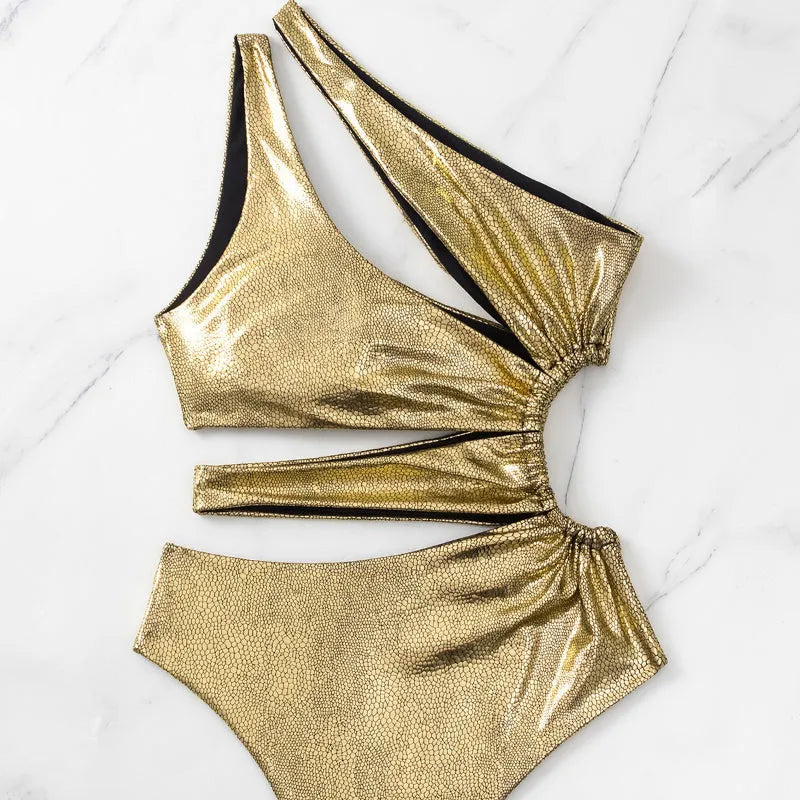 Gold women's one-piece swimsuit with backless and sleeveless design on a mannequin.