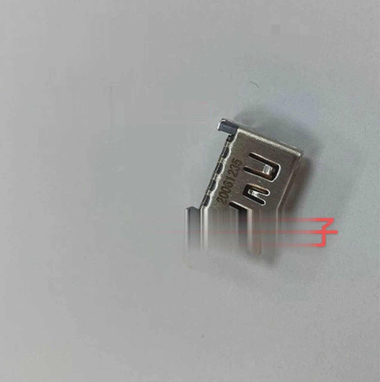 Silver-coloured HDMI host socket interface for game console repair.