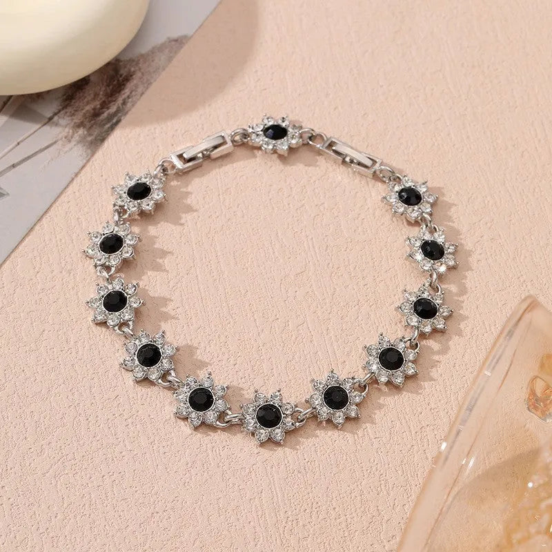 Electroplated zinc alloy flower bracelet in a choice of gold or silver finishes with coloured gemstone designs.