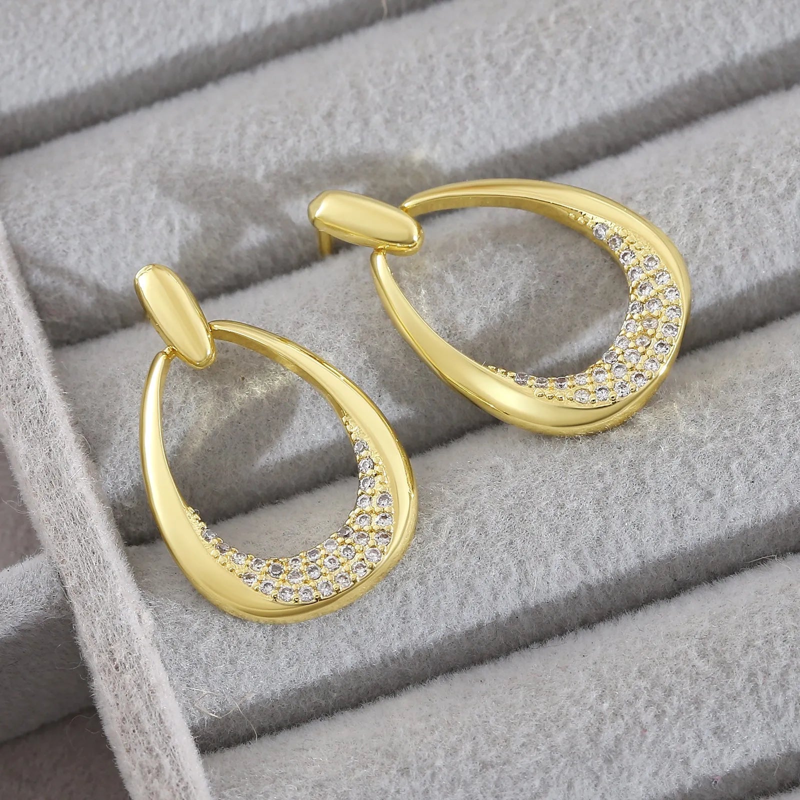 Yellow gold geometric drop earrings with round and oval elements measuring 2.6cm by 1.7cm