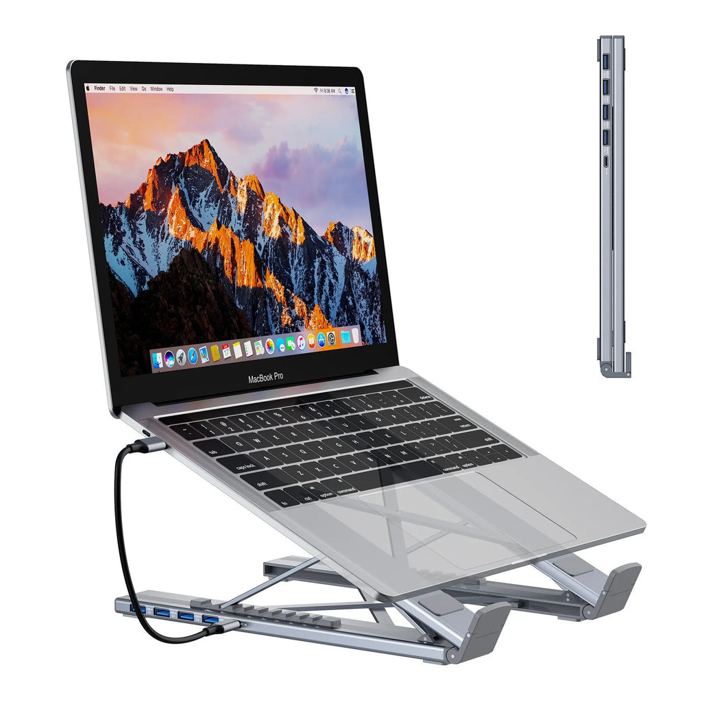 Silver aluminium alloy folding laptop stand with a built-in multi-port docking station hub.