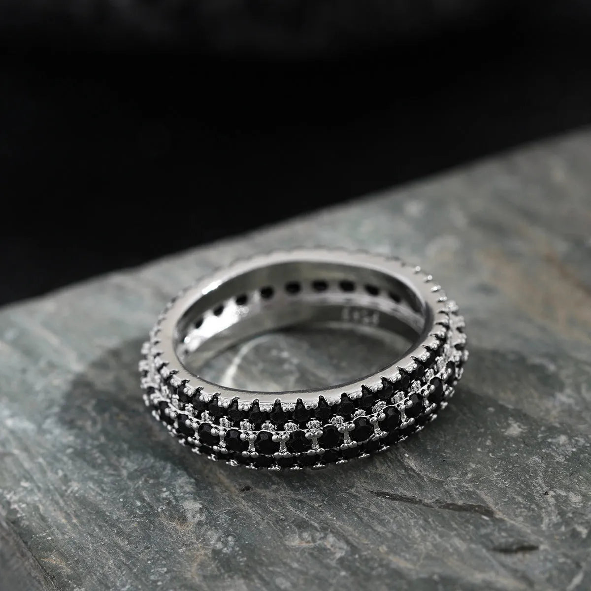 Geometric triangle zircon ring in three colour options showing detailed inlay work