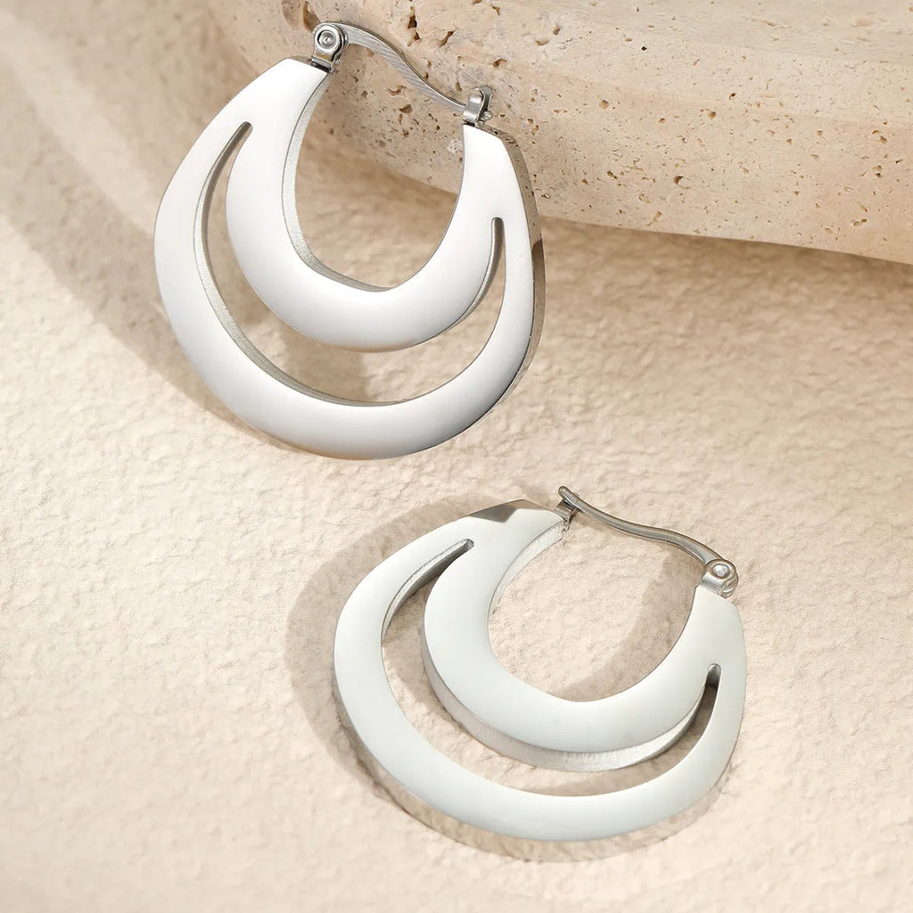A pair of women's geometric French earrings with a round ring design, available in gold or steel colour.