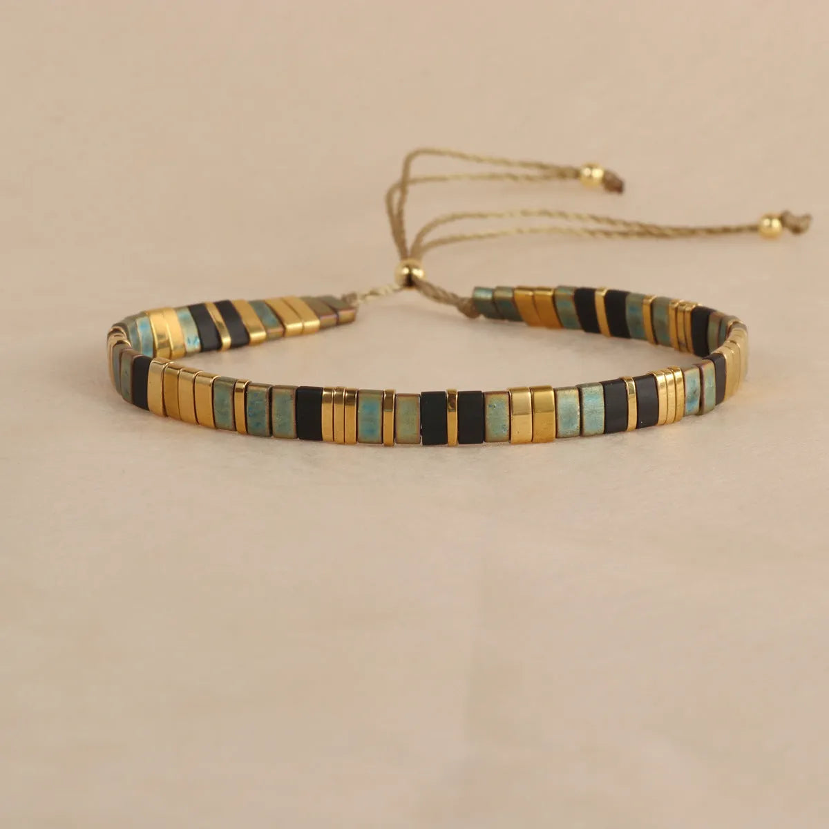 Geometric pull bead bracelet with round glass beads in multiple colour options.