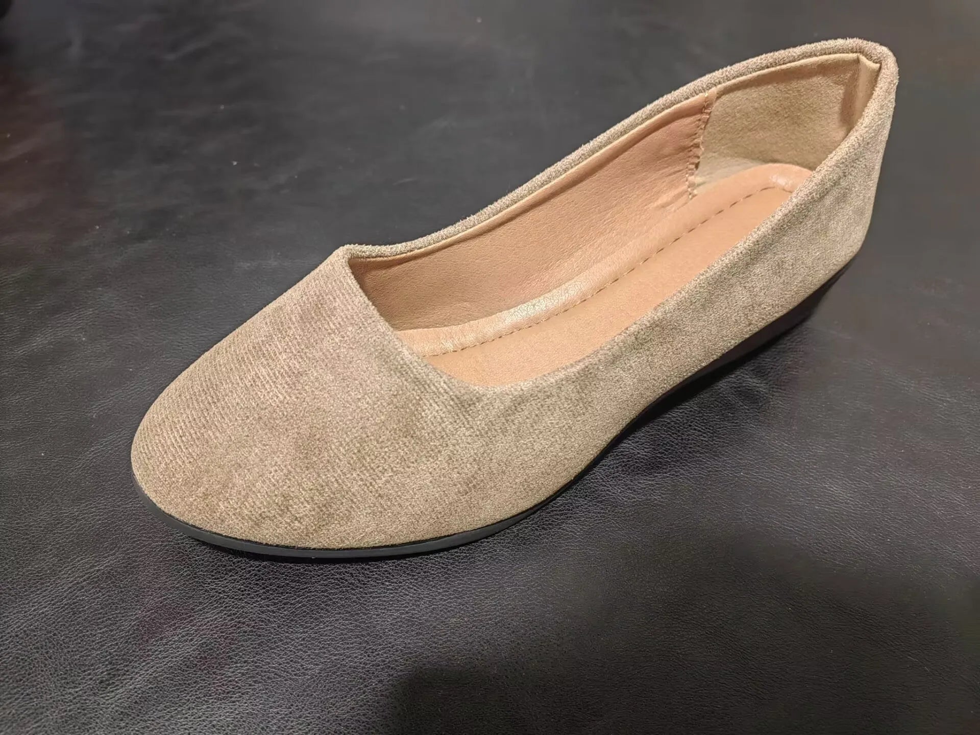 Women's suede wedge pumps in light brown colour showing shallow mouth design and low wedge heel