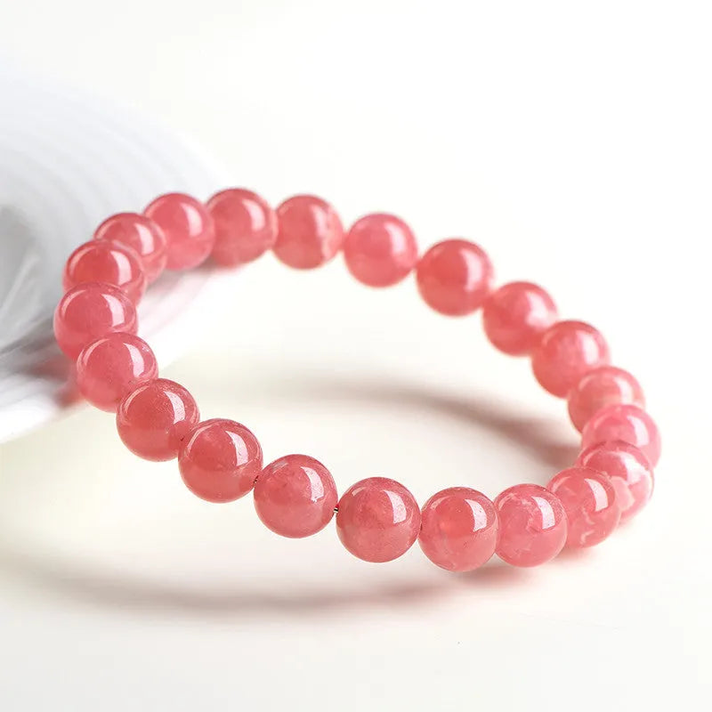Women's geometric crystal bracelet with a red rhodochrosite stone and silver longevity lock clasp.