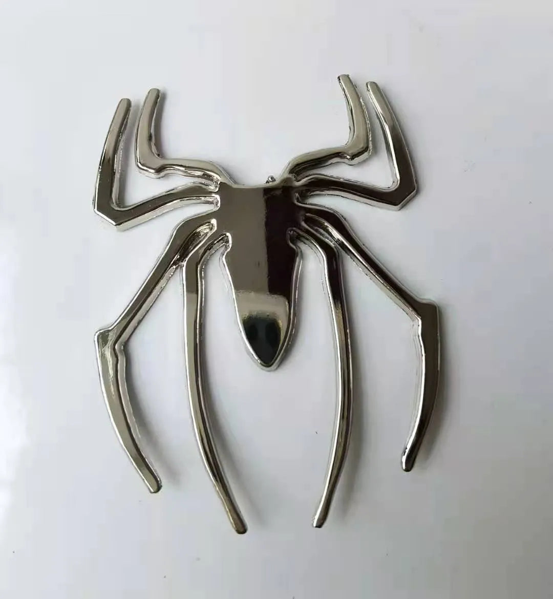 3D metallic spider bumper sticker in gold, silver, black, and red colour options.
