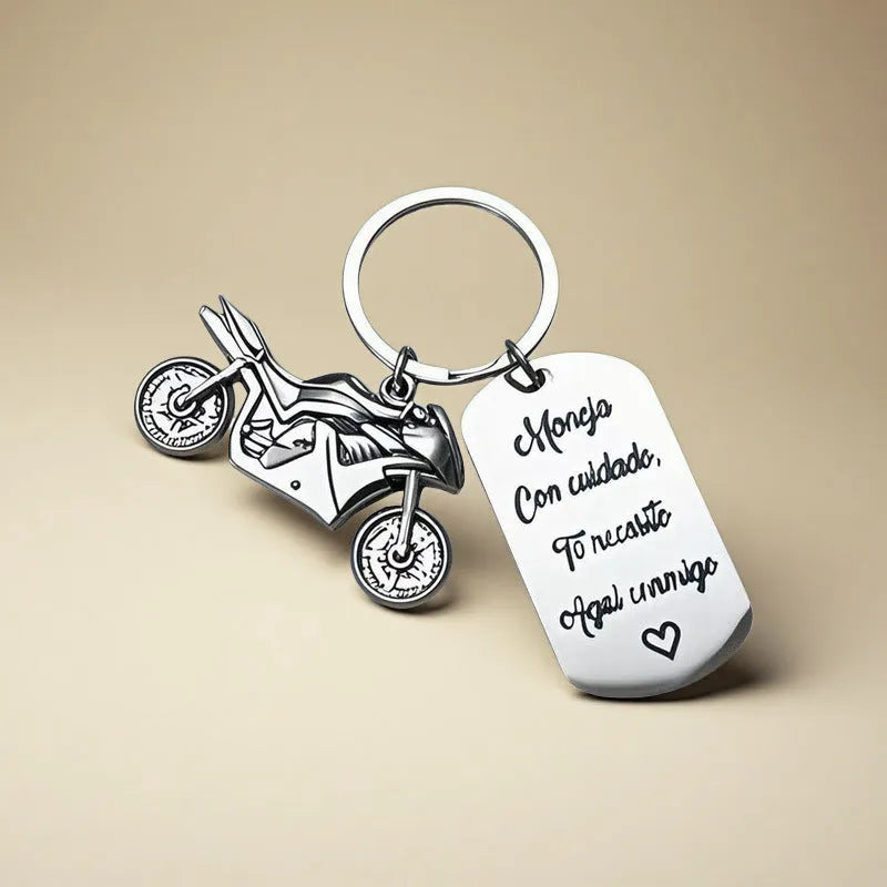 Stainless steel motorcycle keychain with inspirational design on a flannel bag.
