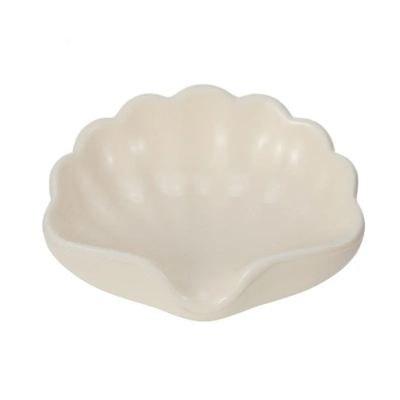 Shell-shaped plastic soap dish in white or pink for bathroom use