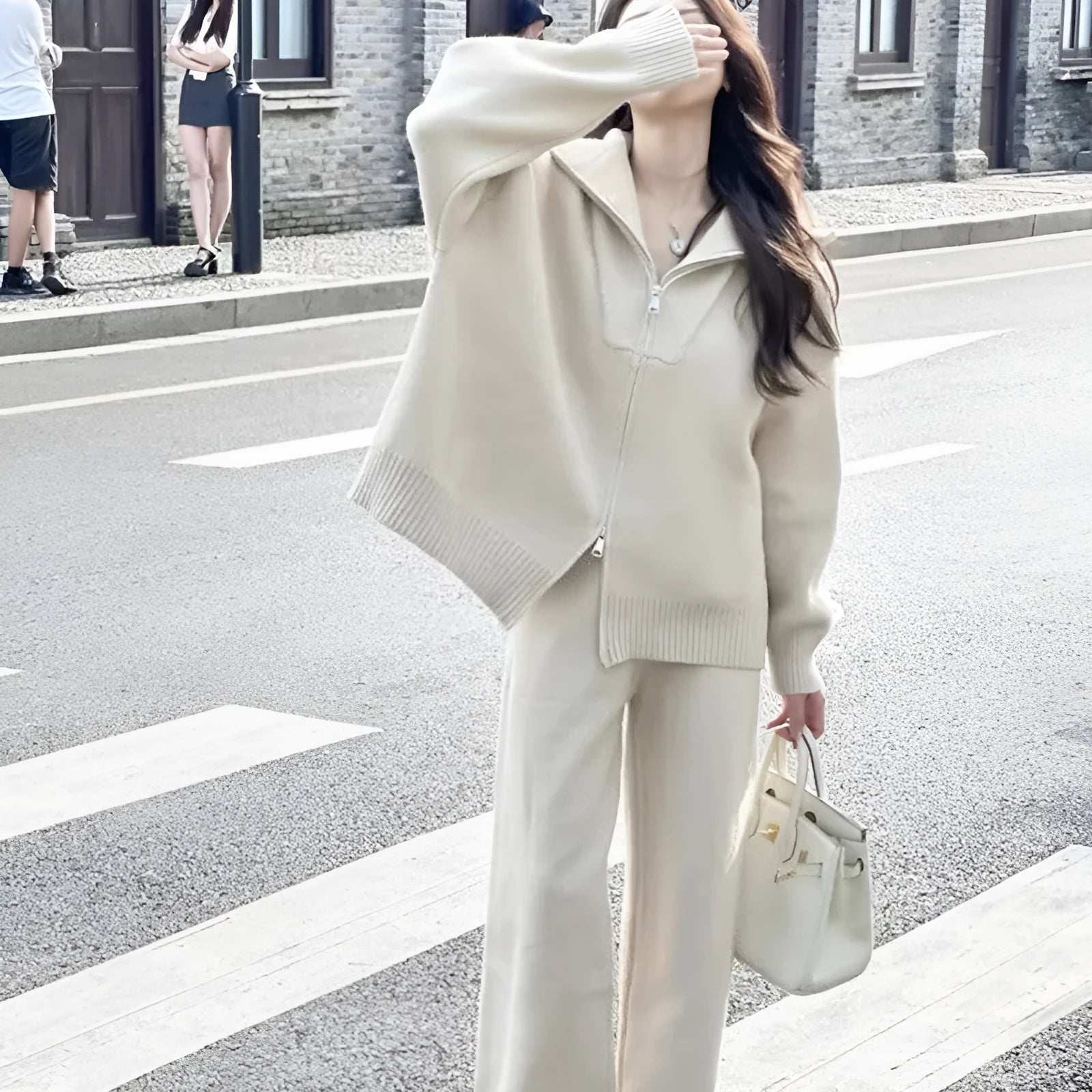 Beige knitted zip cardigan and wide-leg trousers two-piece set on a model