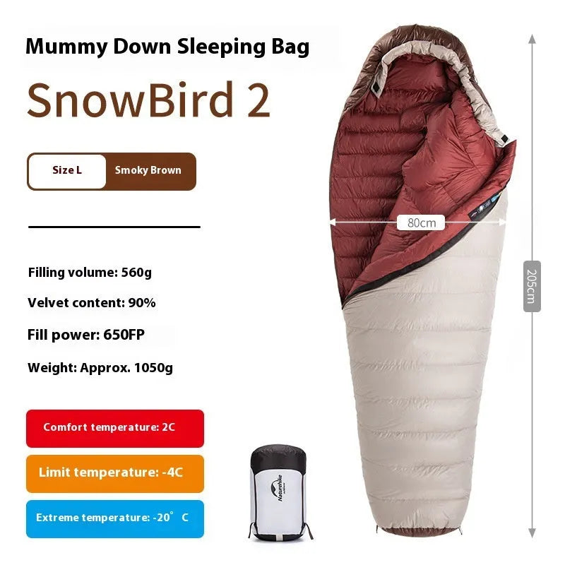 Adult mummy-style sleeping bag with goose down insulation shown with its storage bag.