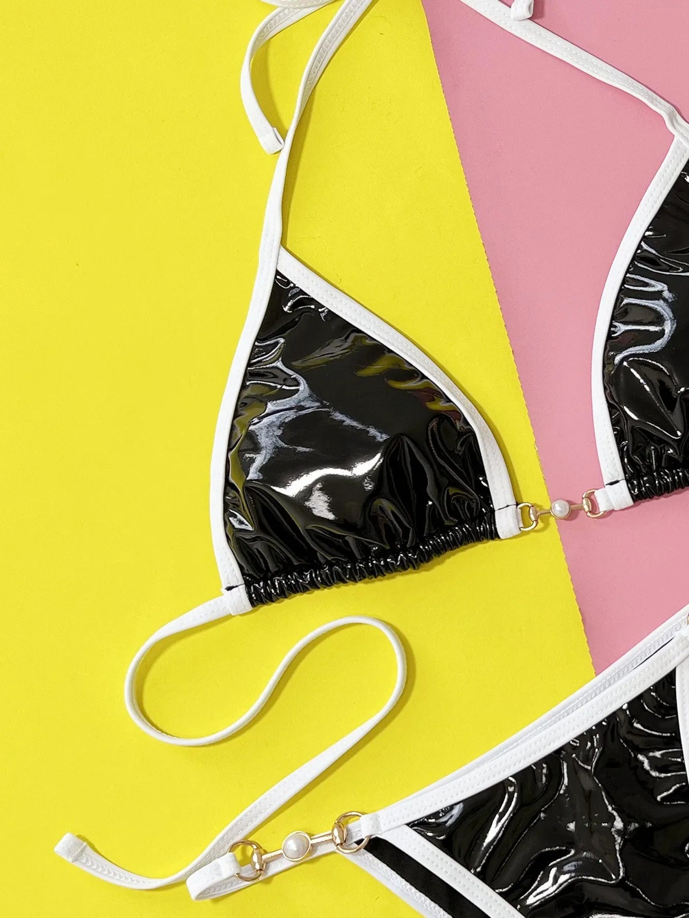 Black women's split bikini swimsuit set with bra and briefs on white background