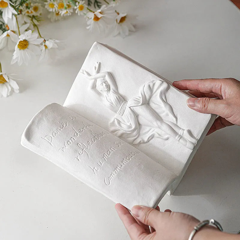 Ceramic book stand in a modern simple style with a glazed decorative pattern, holding a book upright.