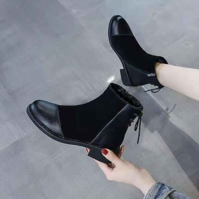 Women's black knee-high Martin boots with side zip closure and bow detailing