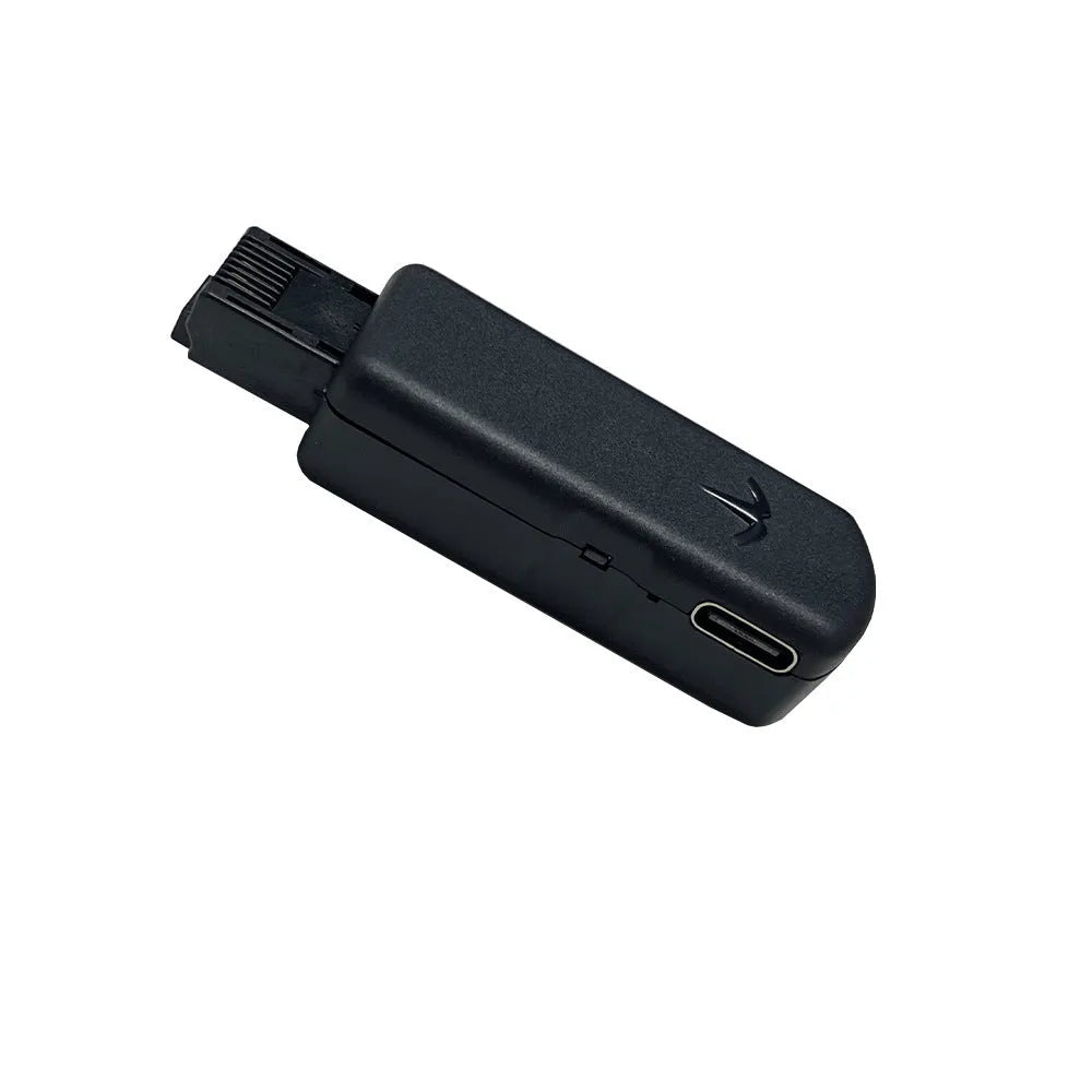 Black JB Tool USB gaming adapter with alloy construction next to its data cable and user manual.