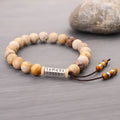Handmade wood colour stone bead bracelet with retro design on a wrist