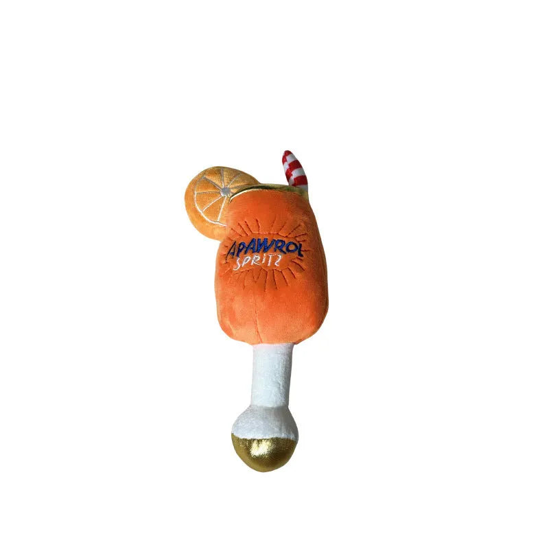 Yellow beer bottle shaped plush squeaky dog toy with cup handle on a white background.